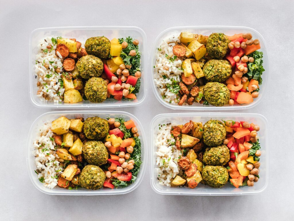 pexels-photo-1640771-1640771 Colorful meal prep containers with falafel, chickpeas, rice, and vegetables for a healthy lifestyle.